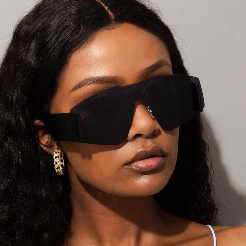 "Lunettes de soleil oversize en une pièce, style catwalk féminin pour un look audacieux et élégant. Protection UV et confort pour les journées ensoleillées."