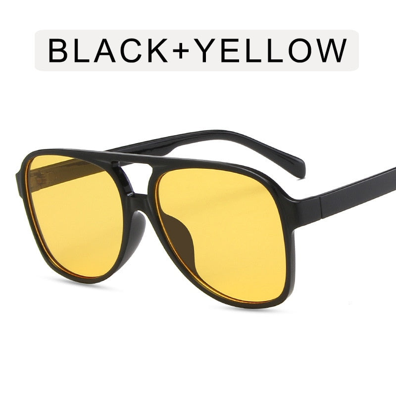 "Lunettes de soleil vintage oversize avec monture carrée rétro, en noir et jaune, parfaites pour un look audacieux et stylé."