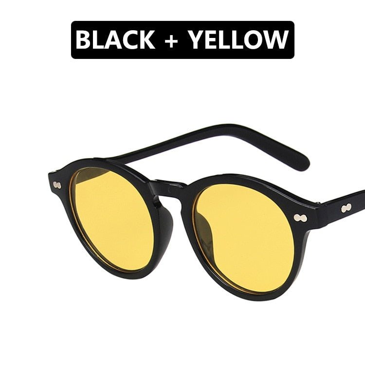 "Lunettes de soleil rondes vintage avec monture fine et verres jaunes, offrant un style rétro unique et une protection contre la lumière, parfaites pour un look tendance."